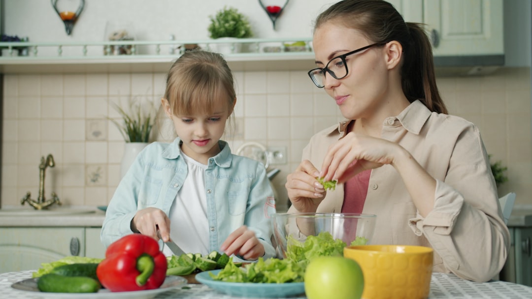 Copil zâmbitor mâncând un măr verde, simbolizând alimentația sănătoasă pentru copii